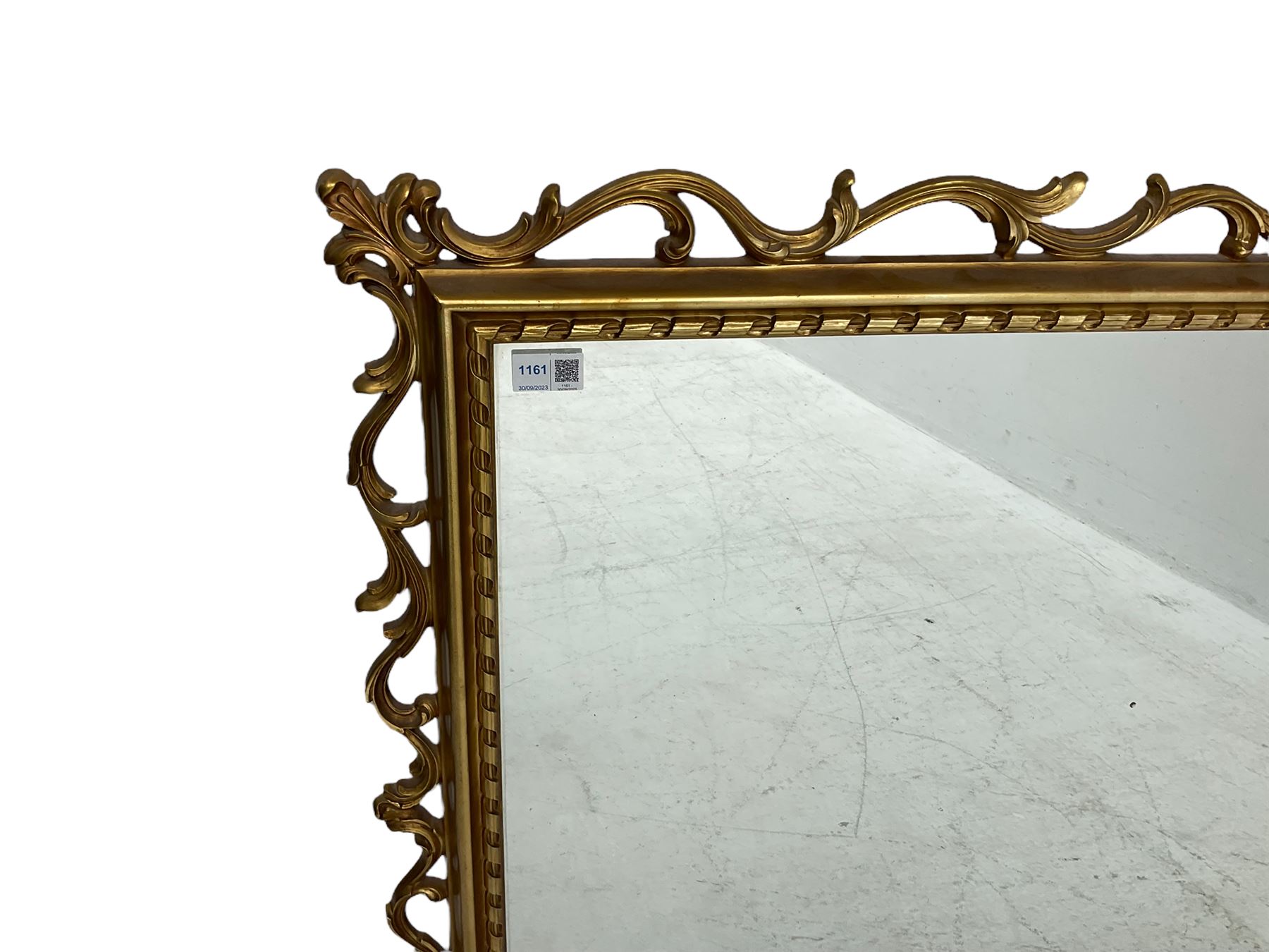 Ornate gilt framed mirror, decorated with trailing and scrolled foliage, plain mirror plate