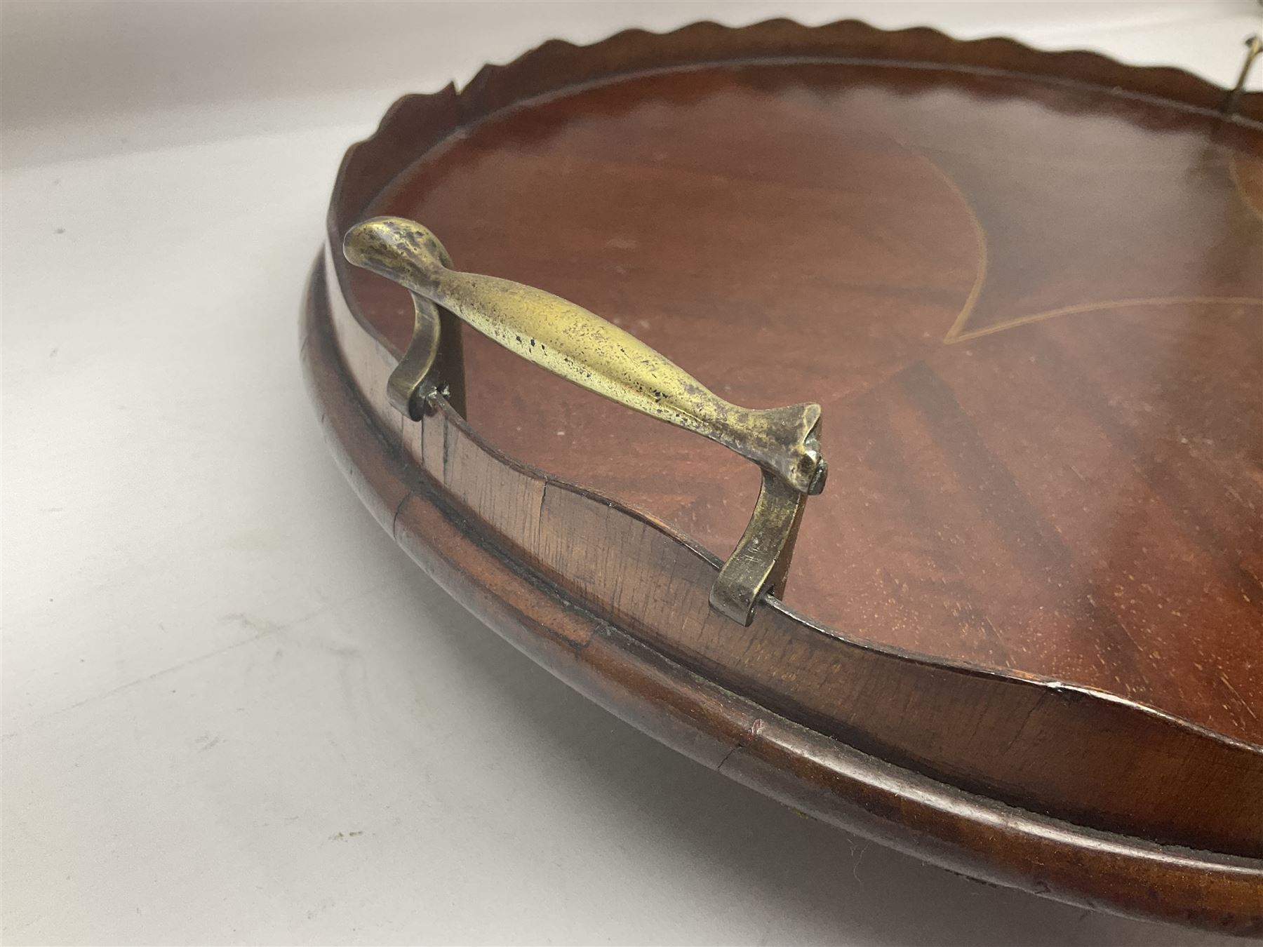 Early 20th century mahogany tray, of oval form with shaped rim and twin brass handles, with inlaid diamond decoration to centre, W67cm