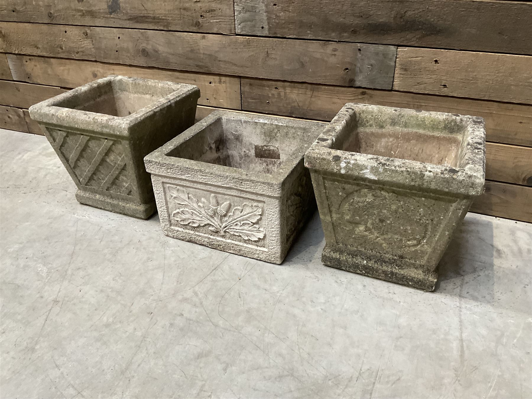 Pair of square cast stone planters, single planter with leaf decoration and a rectangular brick effect planter (4)