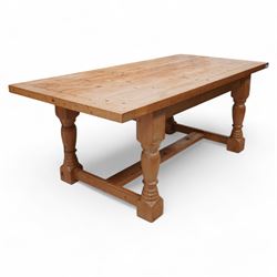 Waxed pine refectory table, boarded top with cleated ends, on turned supports united by H-stretchers 