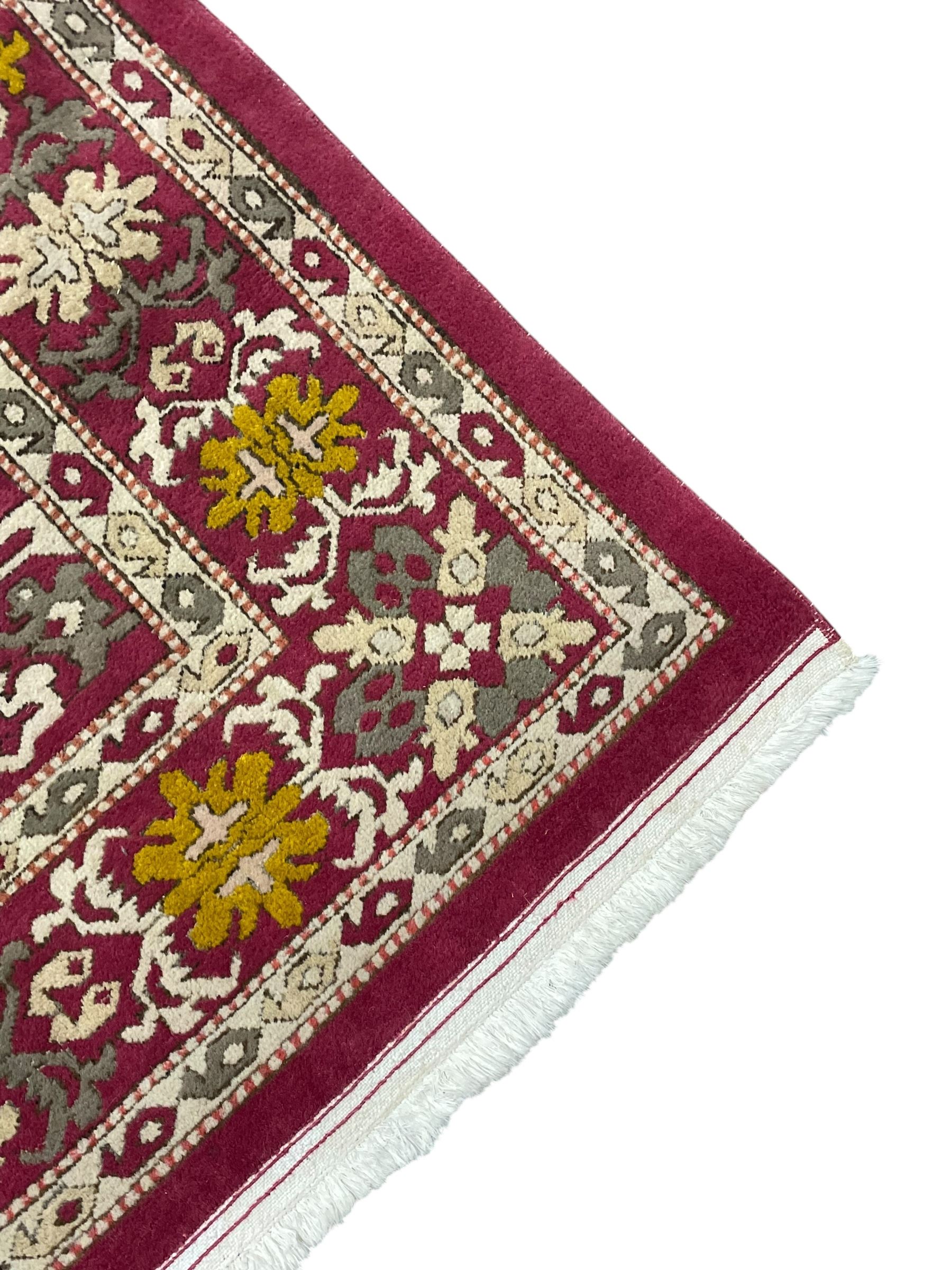 Persian design red ground rug, decorated with stylised plant motifs, repeating border within Boteh decorated guard stripes 