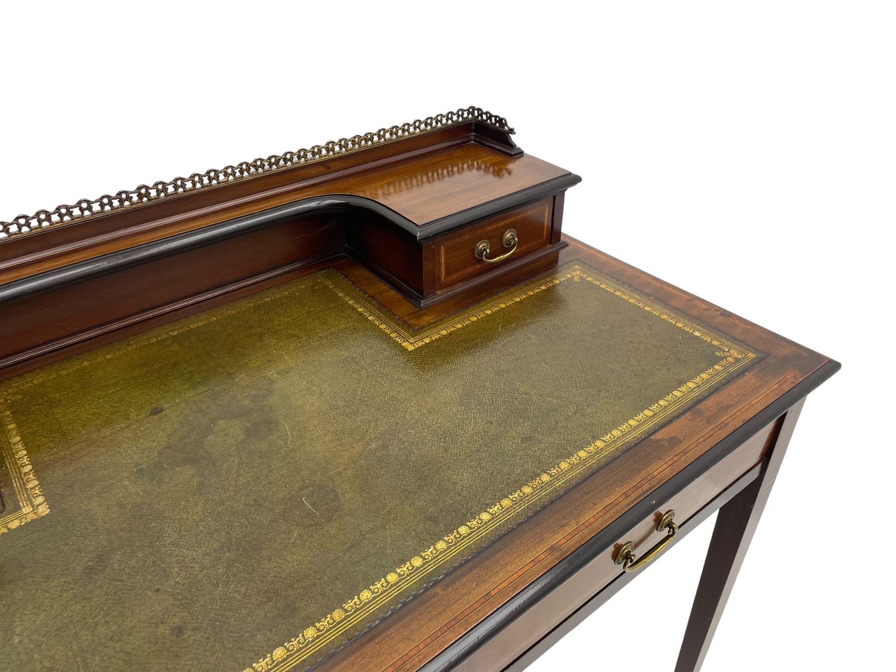 Edwardian inlaid mahogany writing desk, raised back with gilt metal gallery over two small drawers with satinwood banding, the rectangular moulded top with green leather inset writing surface, fitted with two drawers, on square tapering supports with spade feet, brass and ceramic castors 