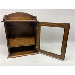 Edwardian oak smokers cabinet with the single glazed door to fitted interior having a single draw and pipe rack, H40cm