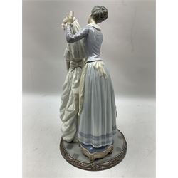 Lladro figure, My Wedding Day, modelled as a bride preparing for the ceremony with her mother adding flowers to her veil, sculpted by Jose Puche, with original box, no 1494, year issued 1986, year retired 1997, H38cm