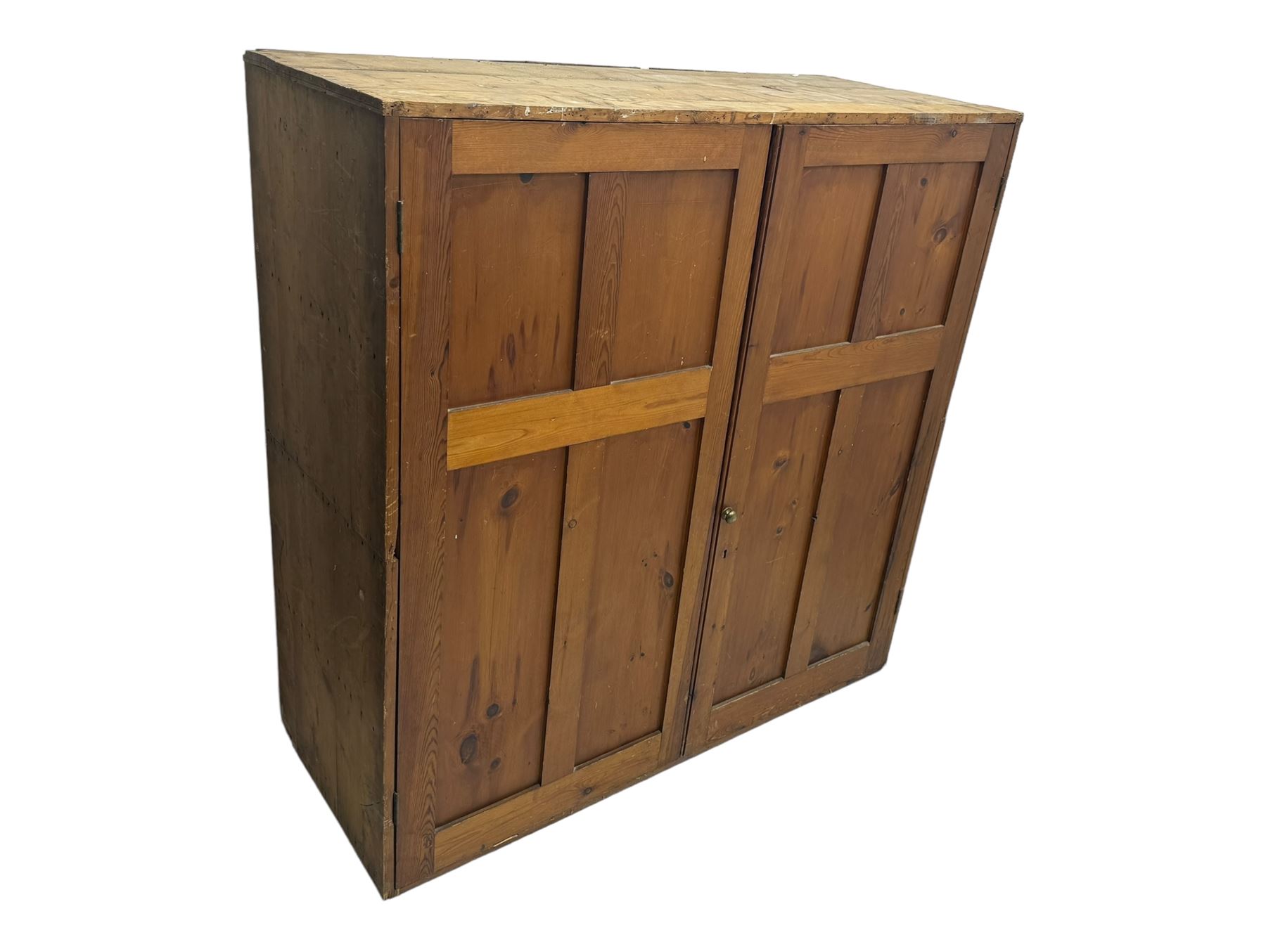 Large 19th century pine cupboard, rectangular top over two panelled later doors, enclosing four open shelves, on plinth base