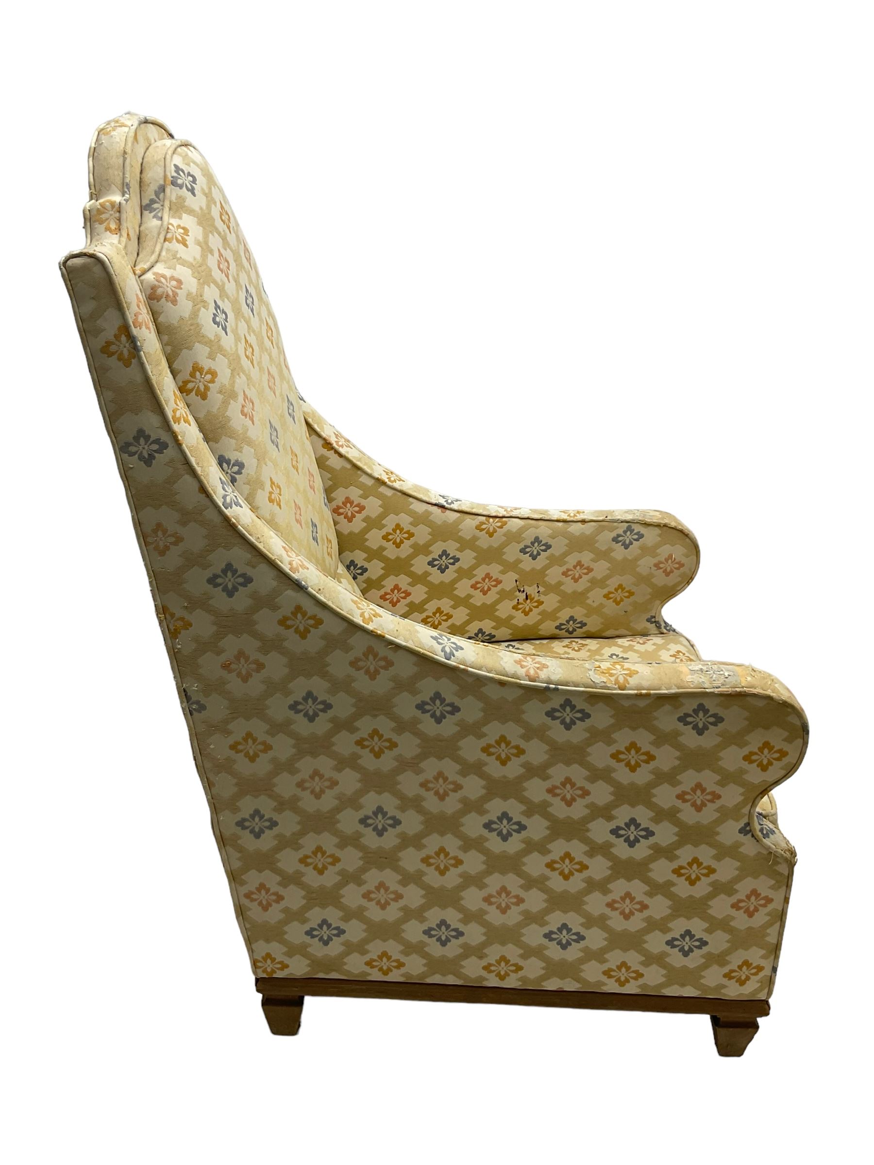 Spanish high back throne armchair, arched cresting rail over scooped arms, upholstered in gold and ivory patterned fabric, on a pitch pine base with spade feet