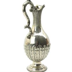 Victorian silver plated claret jug, the body of baluster form, with scroll handle, textured neck and the base cast with stiff leaves, on a beaded circular pedestal foot, H34.5cm 