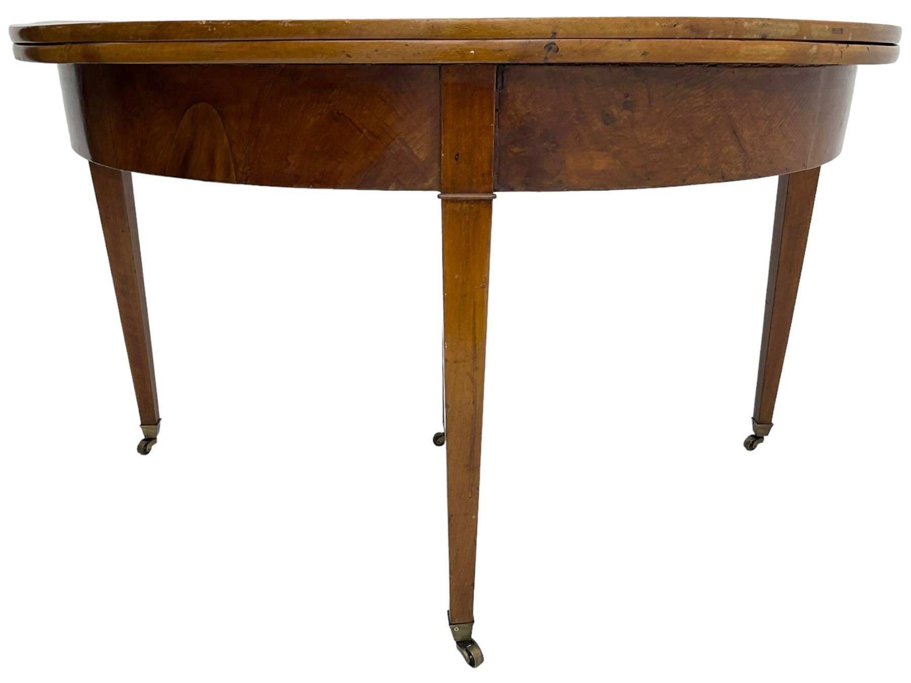 19th century mahogany demi-lune console table, hinged fold-over top with single drawer, on tapered supports with brass castors