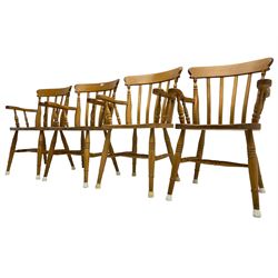 Set of seven beech farmhouse dining elbow chairs, stick back over saddle sat, raised on ring turned supports united by H-stretcher