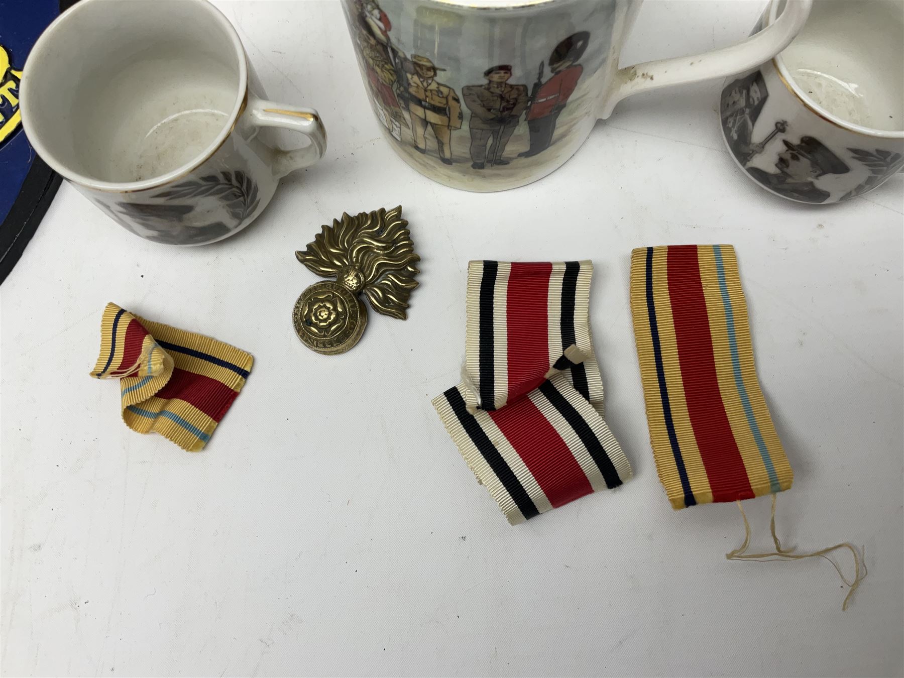 Collection on military items, including John Player & Sons Military Uniforms of the British Overseas, medal ribbon, ceramics and a reproduction metal plaque 