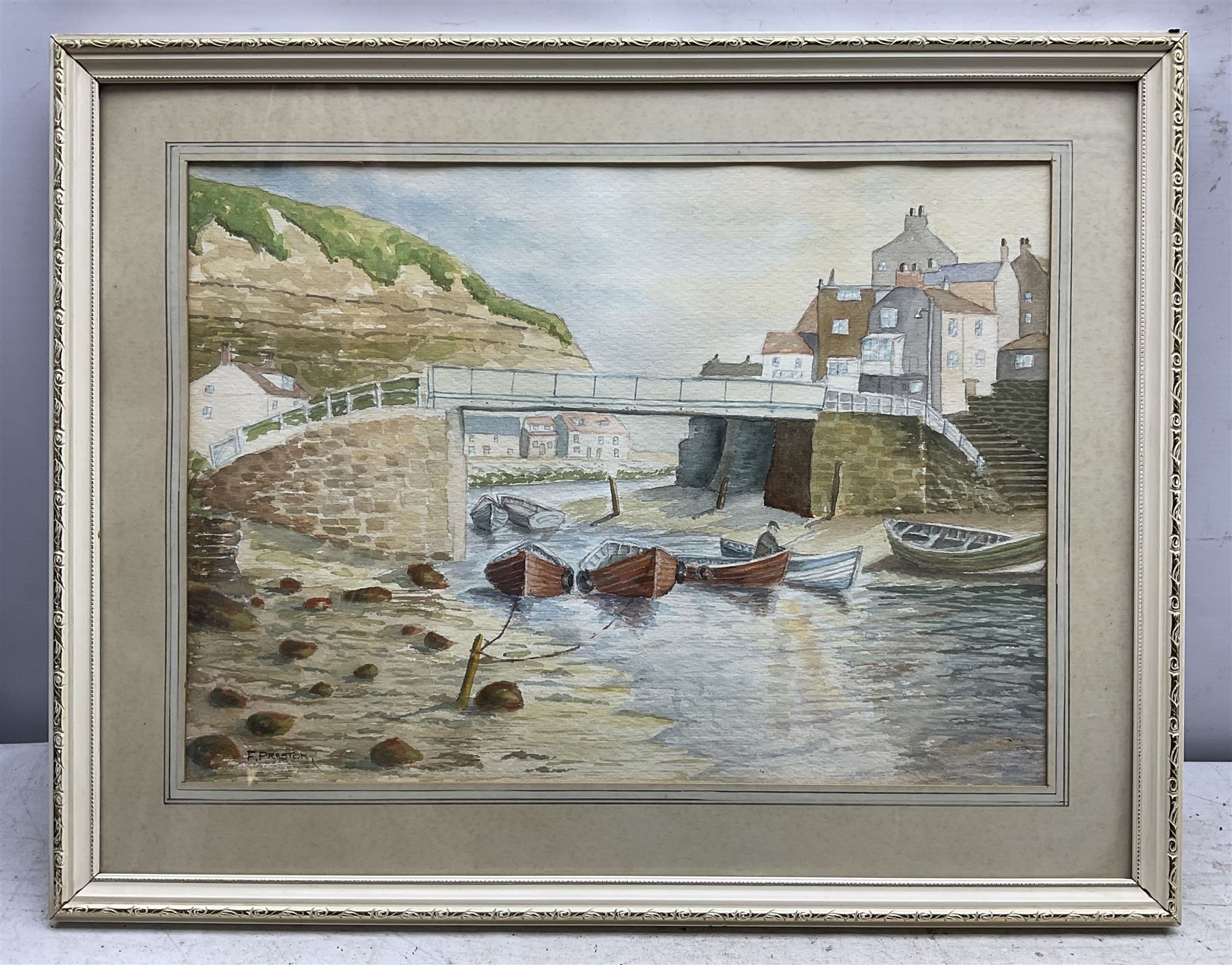 F Preston (British 20th Century): 'Staithes - The Beck', watercolour signed, titled and dated 1977 verso 17cm x 37cm; Roy Williams (British 20th Century): 'Robin Hood's Bay', charcoal signed and dated '92, 21cm x 30cm; together with a watercolour of barges signed 'Turner' (3)