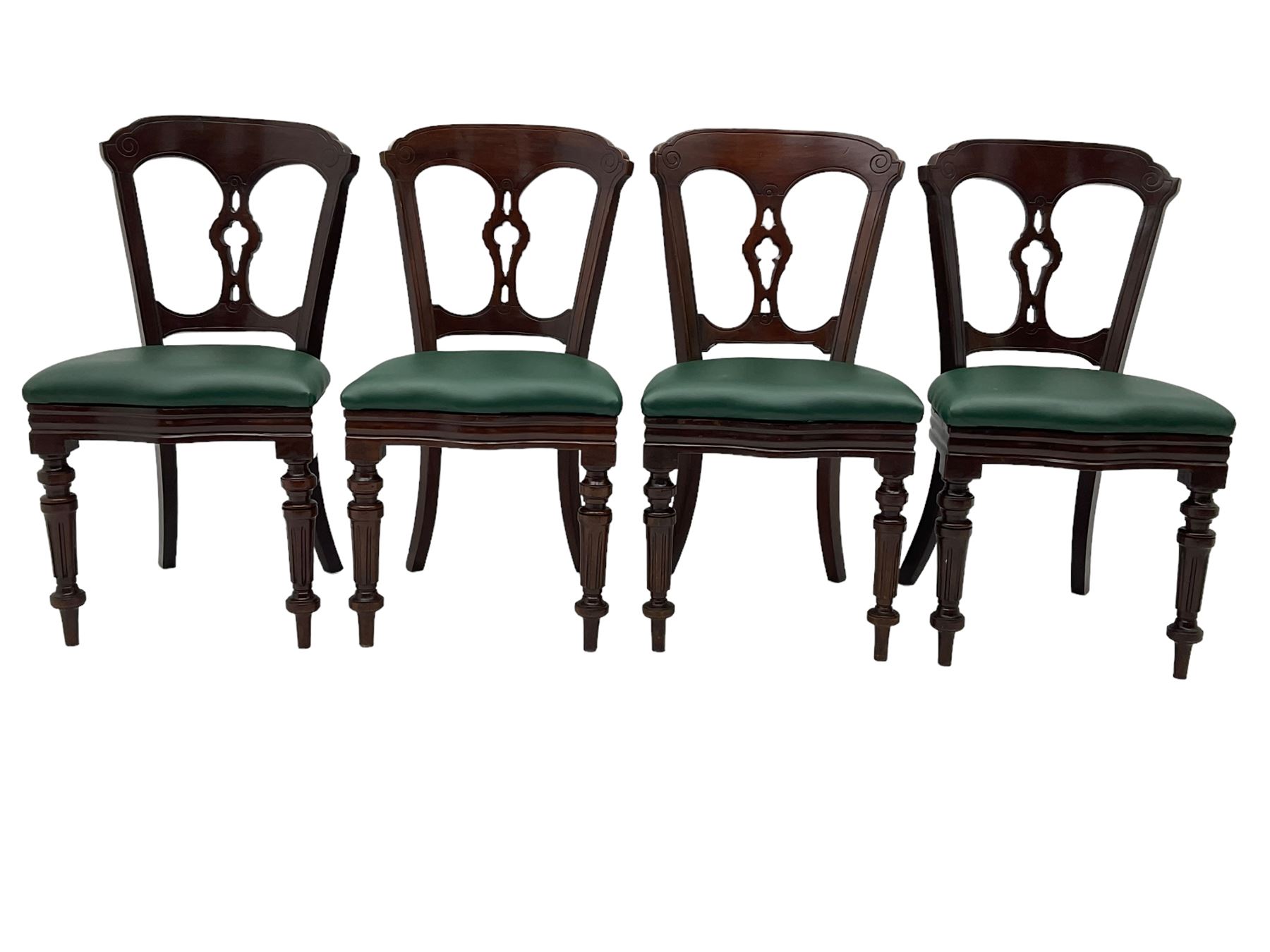 Matched set of twelve Victorian mahogany dining or boardroom chairs, the shaped cresting rail decorated with scrolled decoration, upholstered drop-on seats upholstered in green fabric, on turned supports  