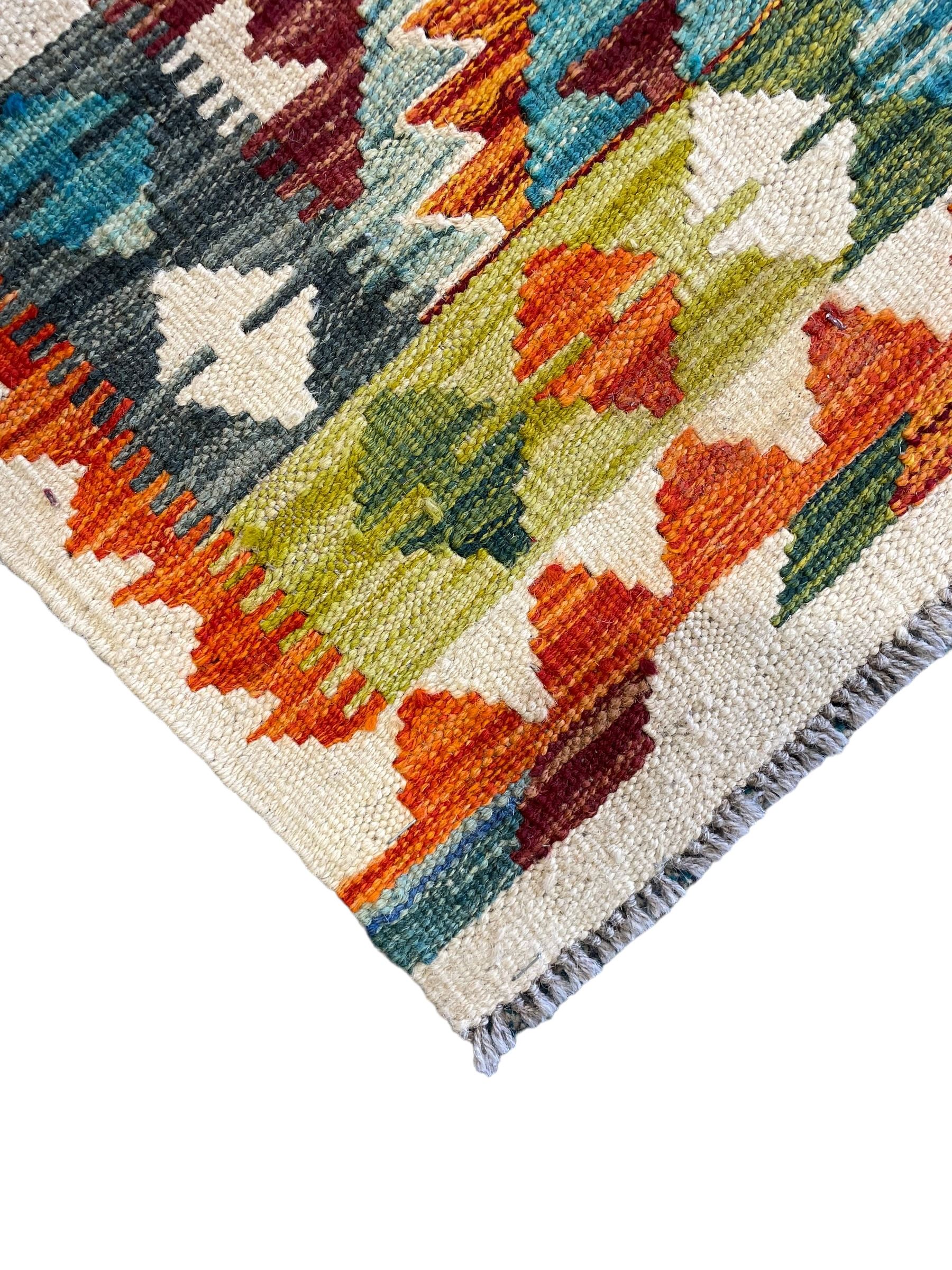 Chobi Kilim ivory ground rug, the busy multi-coloured field decorated with two concentric lozenges, the guard lines decorated with broken-lozenge motifs and geometric designs