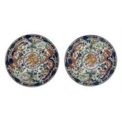 Pair of Chinese 'Dragon & Phoenix' porcelain saucers, centrally painted with a five claw dragon chasing the flaming pearl in iron red and gilt, within a border of confronting Dragons and Pheonix, amongst floral blooms, six character Guangxu mark beneath, D13.5cm