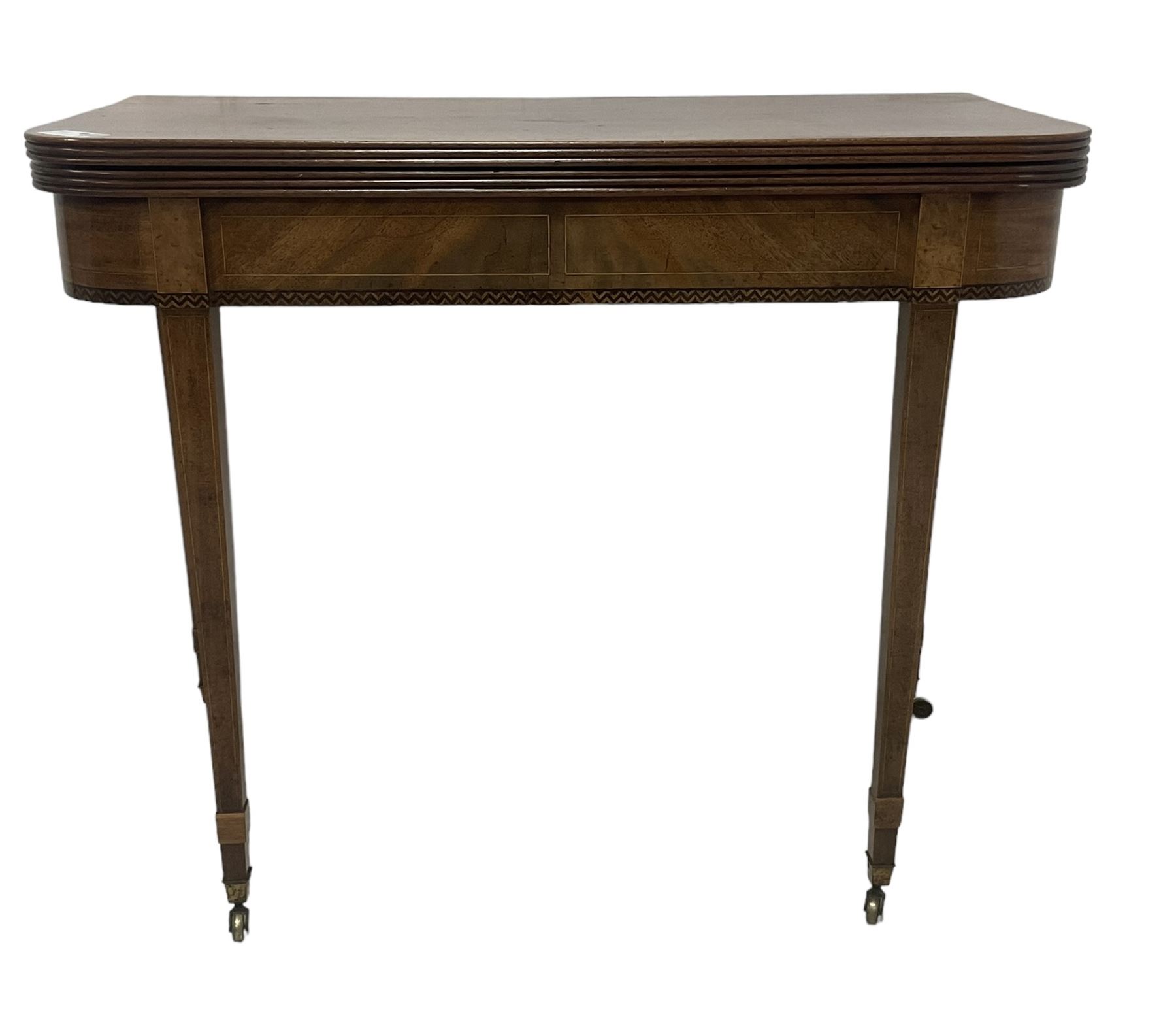 19th century mahogany tea table, fold-over top with reeded edge over inlaid frieze, on double gate-leg action square tapering supports, with brass castors