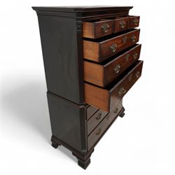 George III mahogany chest-on-chest, canted rectangular form, stepped cavetto moulded cornice, the upper section fitted with three short over three long drawers, the lower section fitted with two short over two long drawers, moulded drawer fronts with shaped and pierced handles plates and swan neck handles, enclosed by fluted corners with acanthus leaf capitals, on ogee bracket feet