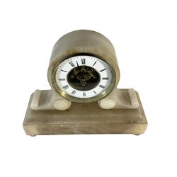 French - late 19th century 8-day mantle clock in an alabaster case,  with a drum movement raised on scroll supports and stepped plinth, open dial displaying the skeleton movement, escapement and motion work, enamel chapter with Roman numerals and spade hands enclosed within a glazed brass bezel, single train tick tac escapement with integral pendulum, wound and set from the front.