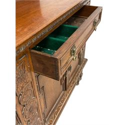 Early 20th century oak sideboard, raised panelled back with foliate carved decoration, rectangular top with gadrooned edge, fitted with two drawers over cupboards with field moulded facias, turned supports joined by stretchers