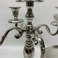 Pair of four branch candelabras, urn-shaped nozzles raised upon scroll branches supported from tapering central stem, with a stepped circular base, H40cm