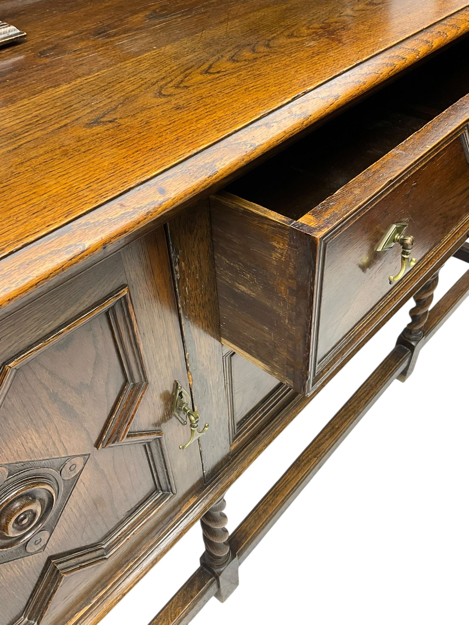 Jacobean Revival oak dresser, projecting moulded cornice over arcade carved frieze and panelled back, on spiral turned supports, moulded rectangular top over two cupboards and two drawers, on spiral turned supports united by moulded stretchers 