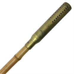 Bamboo cane torch, the pierced brass cover opening to reveal a wick, H144cm