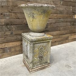 Cast stone vase shaped urn, mounted on square plinth