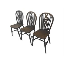 Set of six 19th century elm and ash dining chairs, hoop back with pierced wheel-shaped central splat, shaped saddle seat, raised on turned supports united by H-stretchers