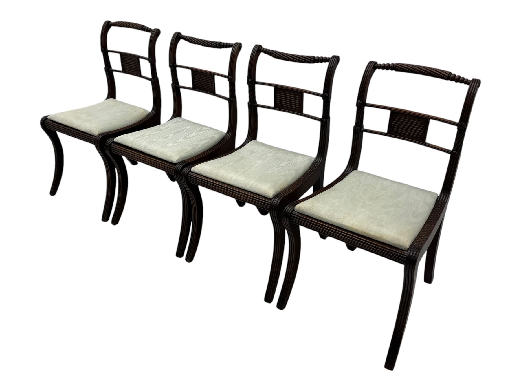 Set of four Regency mahogany dining chairs, rope twist and bead turned cresting rail over reeded middle rail, upholstered drop-in seat, reeded frame and sabre supports