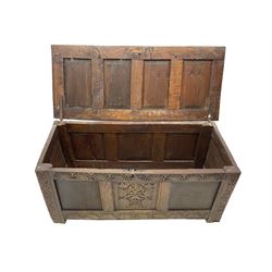 17th century oak blanket chest, quadruple panelled hinged lid over triple panelled front, lunette carved frieze and lower rail, the stile supports carved with scrolled strapwork, moulded frame
