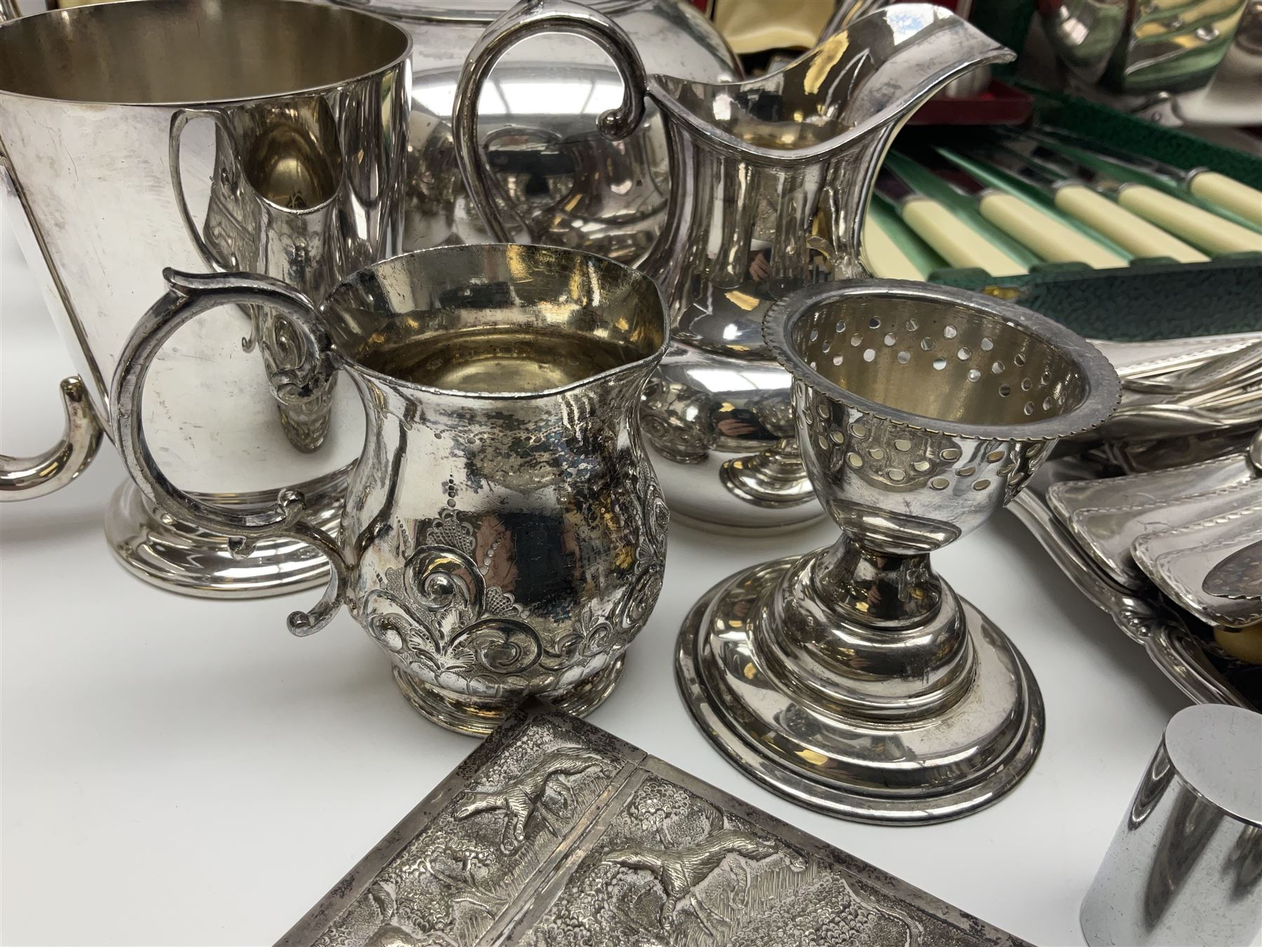 Silver plated four piece tea service, comprising teapot, coffee pot, open sucrier and milk jug, together with card case embossed with animals, flatware etc, 