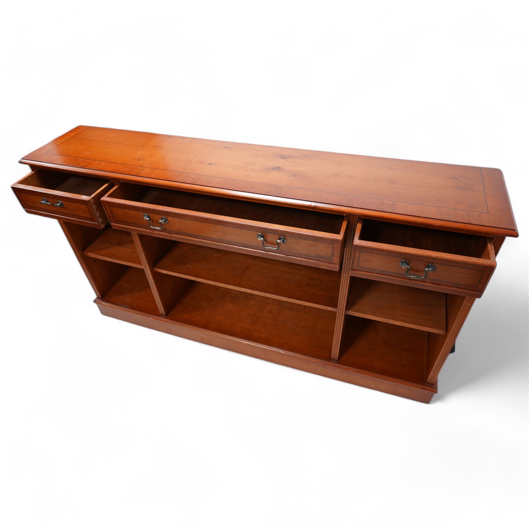 Georgian design yew wood open bookcase, fitted with three drawers above three open shelves, flanked by fluted uprights