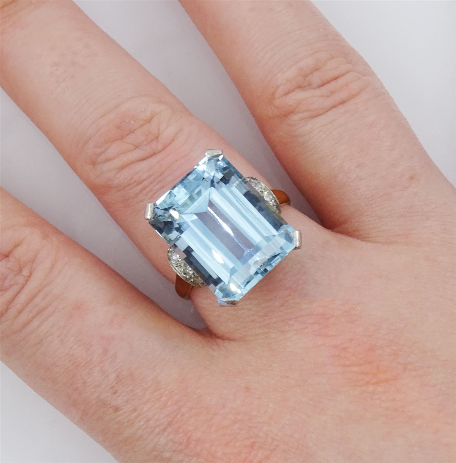 18ct gold single stone emerald cut aquamarine ring, with four channel set diamonds set either side, aquamarine approx 11.15 carat