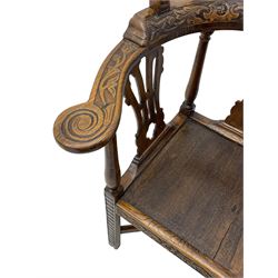 Elm 'Windsor' splat back corner armchair, shaped cresting rail carved with leaves over shaped and pierced splat, the curved arms carved with foliage and scrolled terminals, turned upper supports and a further two splats, panelled seat within foliate carved seat rails, on square rear supports with front shell carved cabriole support, united by plain x-frame stretchers