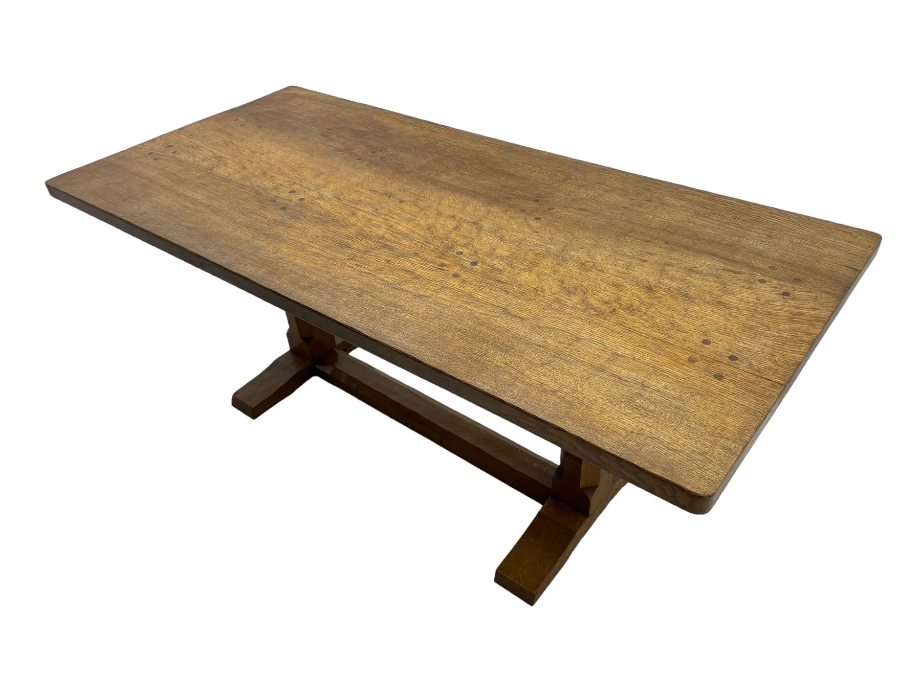 Rabbitman - oak dining table, rectangular adzed top, twin octagonal pillar supports on sledge feet, united by floor stretcher, carved with rabbit signature, by Peter Heap of Wetwang 