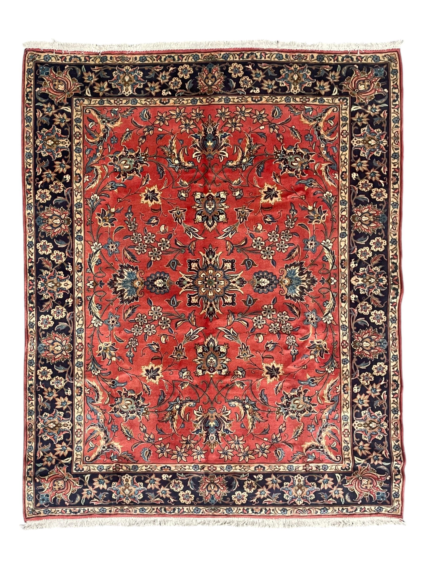 Persian Kashan red ground rug, the field decorated with trailing leafy branches and large palmettes, scrolling border decorated with stylised plant motifs and flower heads, within guard stripes