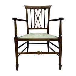 Edwardian inlaid mahogany armchair, curved top rail above spindle backrest with central X-shaped splat, the arms supported by turned uprights, over upholstered padded seat in pale blue damask fabric, on tapered supports with spade feet