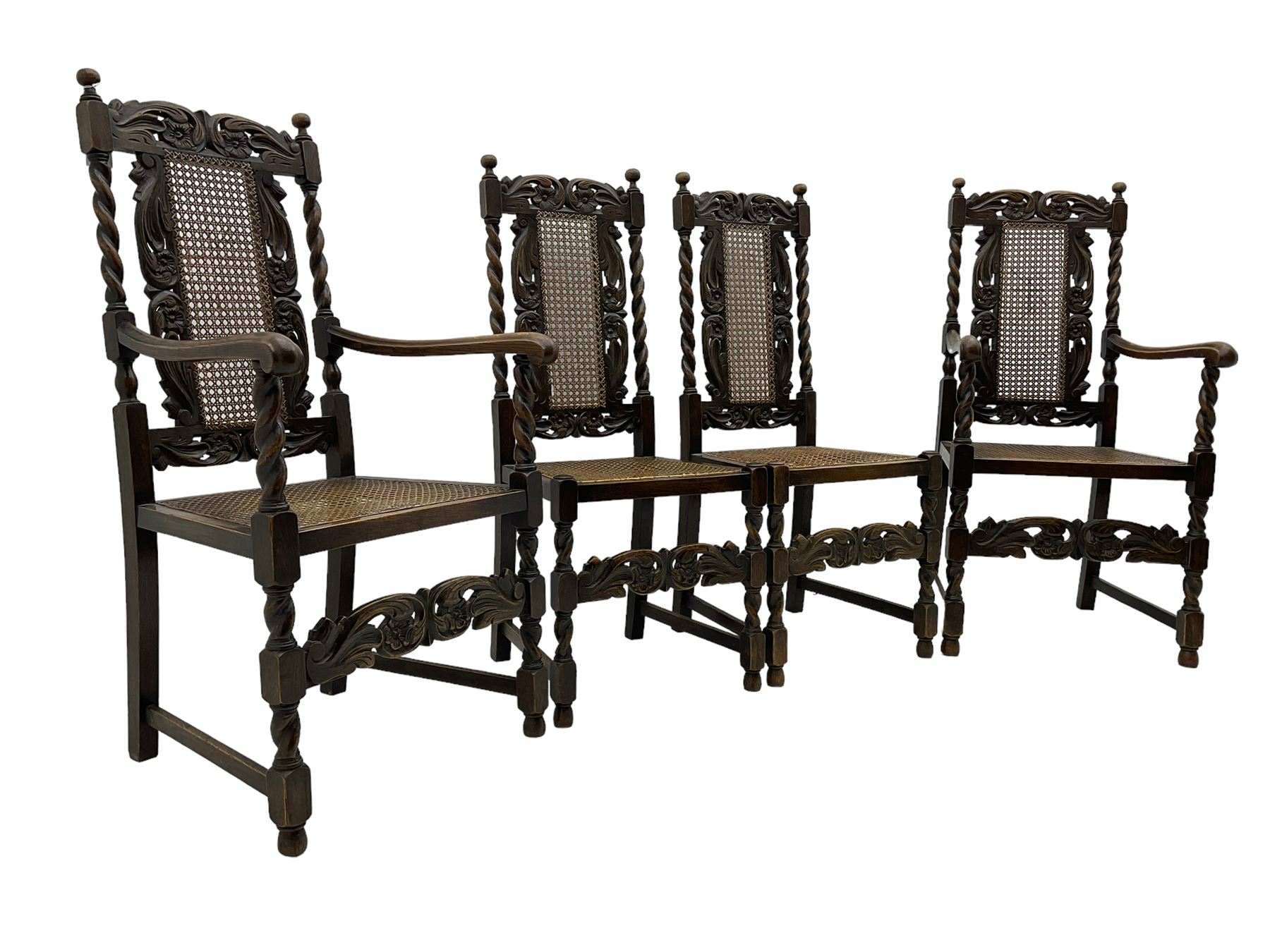 Set of seven (5+2) 19th century Carolean design oak dining chairs, scroll leaf and flower head carved cresting rail over spiral turned uprights and cane work back, the cane work seat on spiral turned supports united by plain stretchers, scrolled leaf carved middle rail 