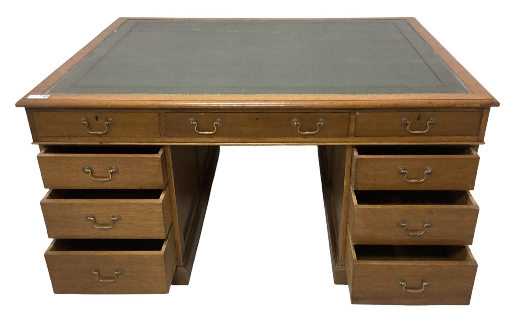 Late 19th century twin pedestal oak partner's desk, rectangular top with inset green leather writing surface, fitted with nine graduating drawers to each side, the rear drawers enclosed by panelled cupboards