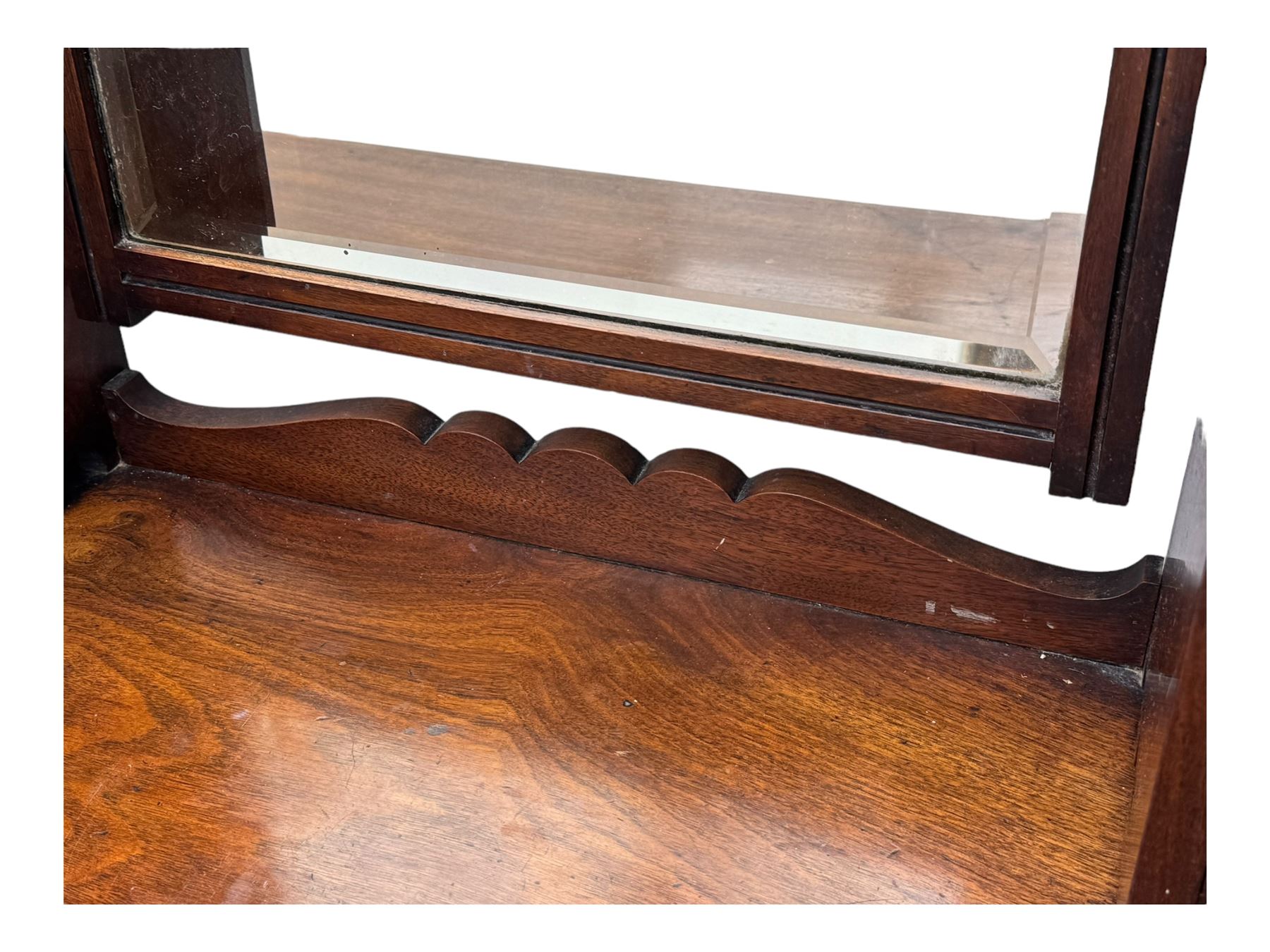 Late Victorian walnut dressing table, raised bevelled swing mirror over small trinket drawers, rectangular moulded top, fitted with two drawers, on turned supports united by undertier 