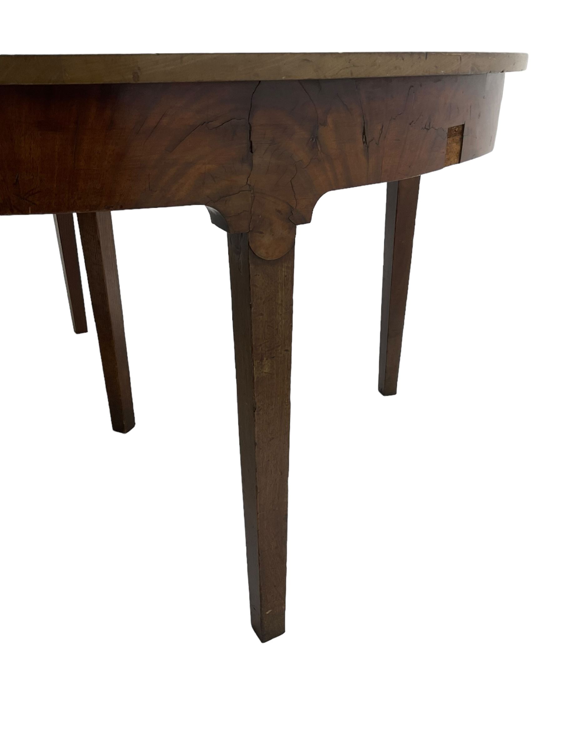 George III mahogany extending dining table, two D-ends with two leaves, on square tapering supports