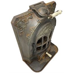 La Salamandre - early 20th century cast iron wood burning stove, decorated with salamander and cartouche motifs, fitted with porcelain handle, on rear castors 