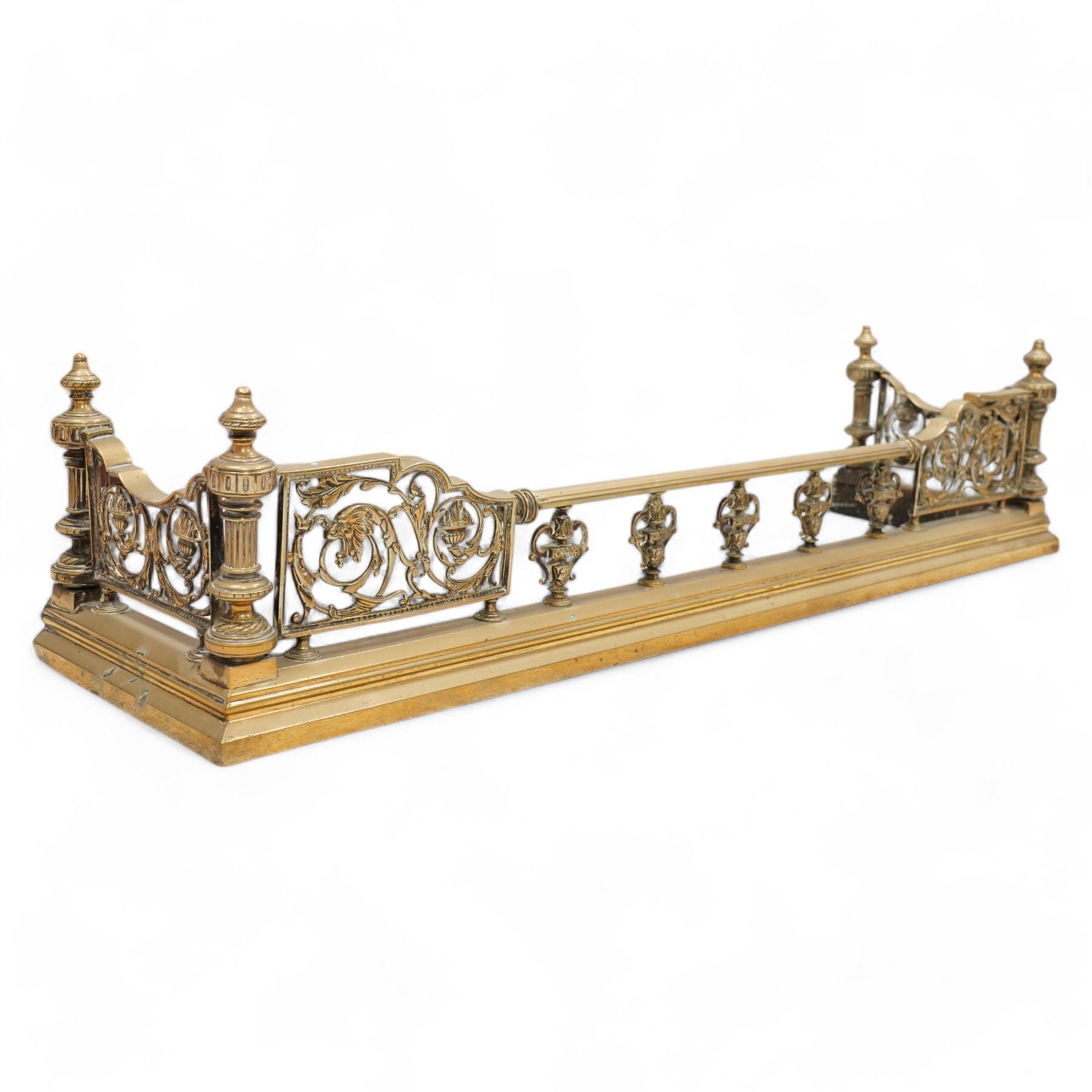 19th century brass fire fender, scrolling acanthus leaf and torch panels to the front and returns, enclosed by four reeded pillars with finials, on moulded curb base 