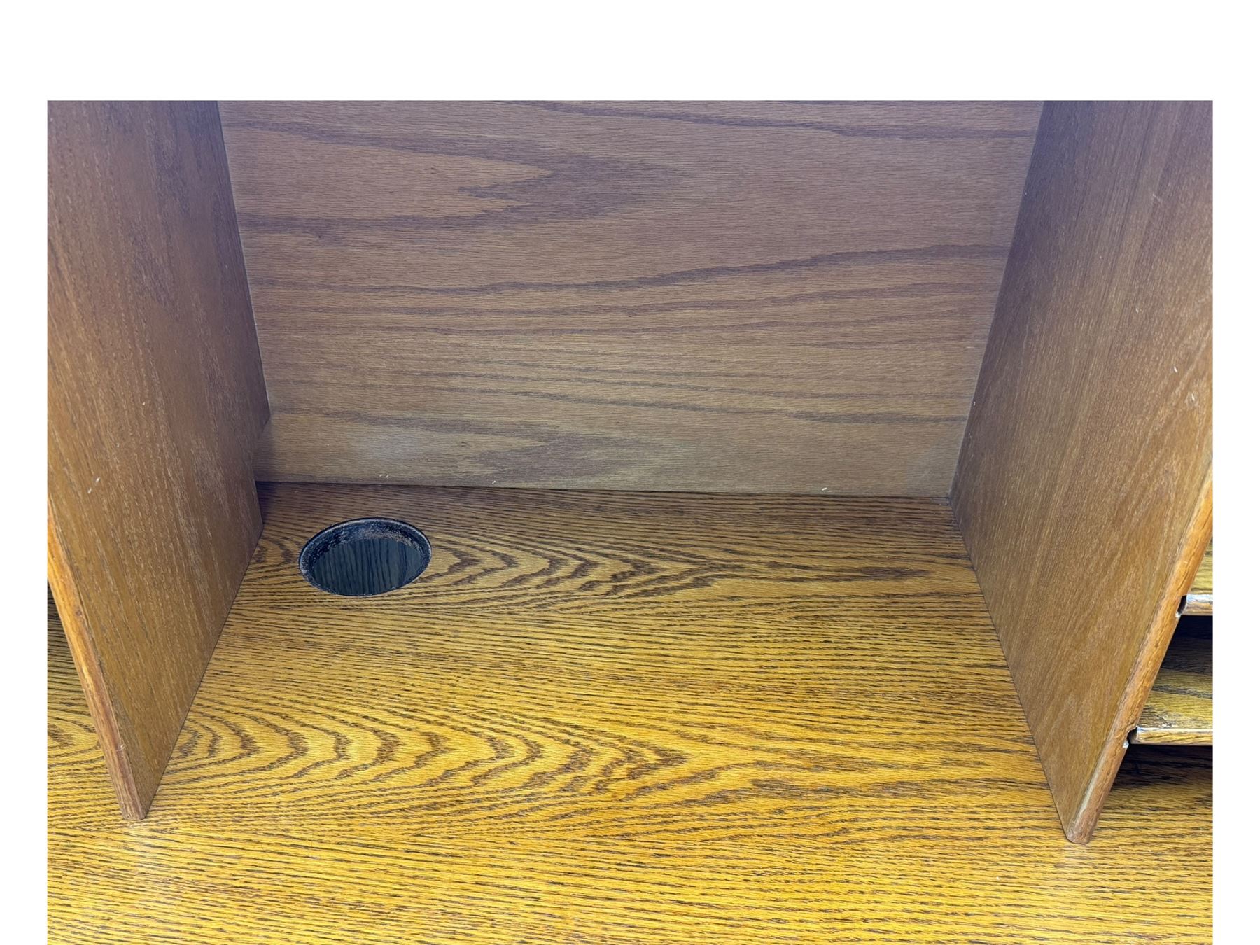 Early 20th century oak tambour roll-top desk, the top with fitted interior including drawers, pigeonholes and compartments, the twin pedestals fitted with four drawers with carved handles, supported by plinth base 