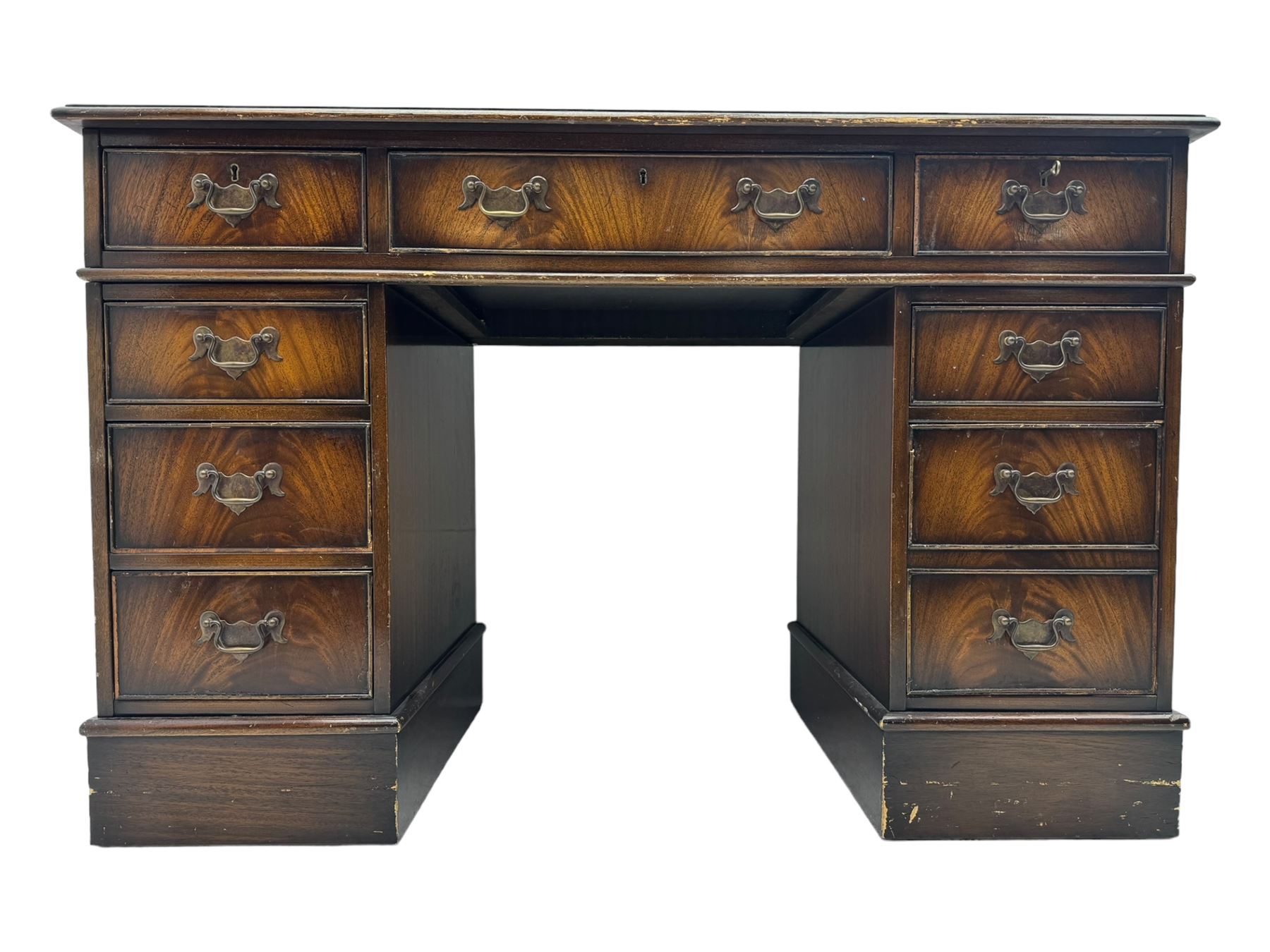 20th century mahogany twin pedestal desk, moulded rectangular top with red leather inset with gilt tooled border, central drawer over kneehole flanked by two banks of four graduating cockbeaded drawers, on plinth base