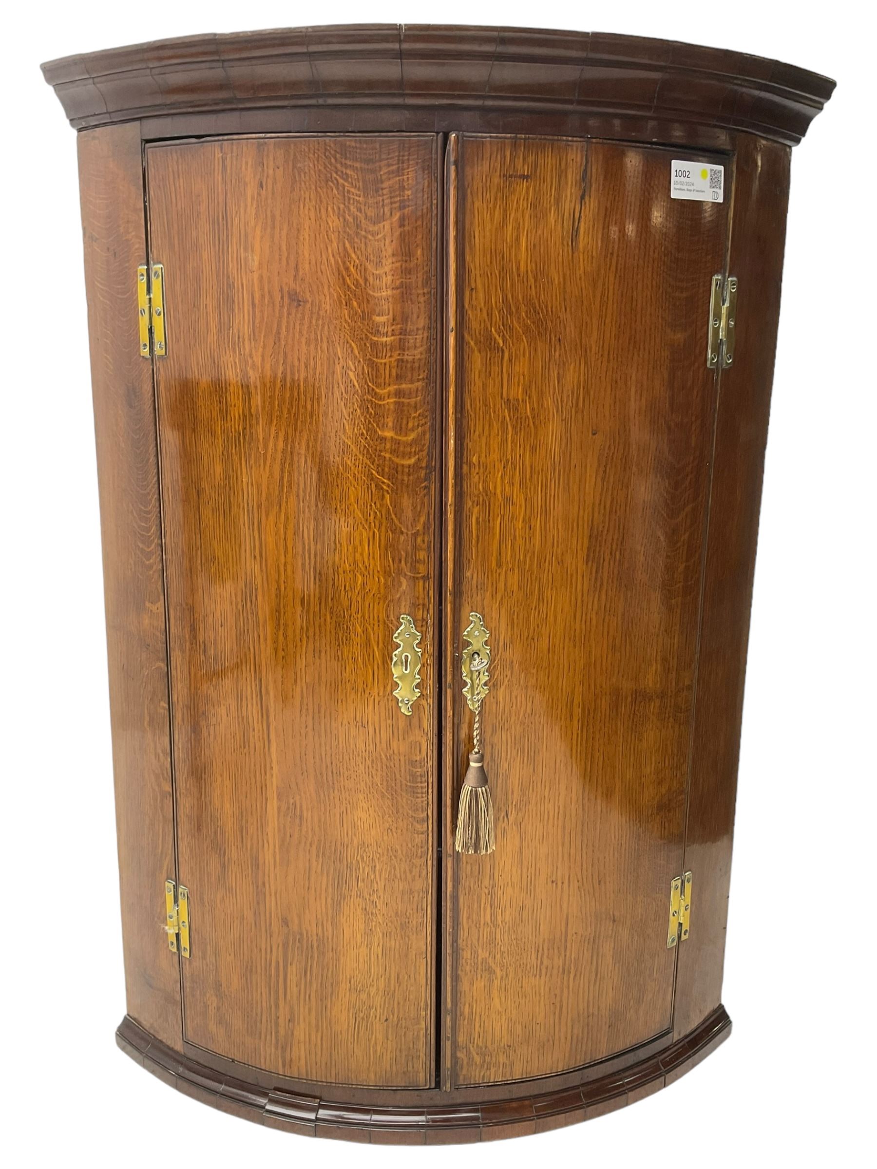 George III oak and mahogany wall hanging cylinder corner cupboard, moulded cavetto cornice over double cupboard enclosing three shelves