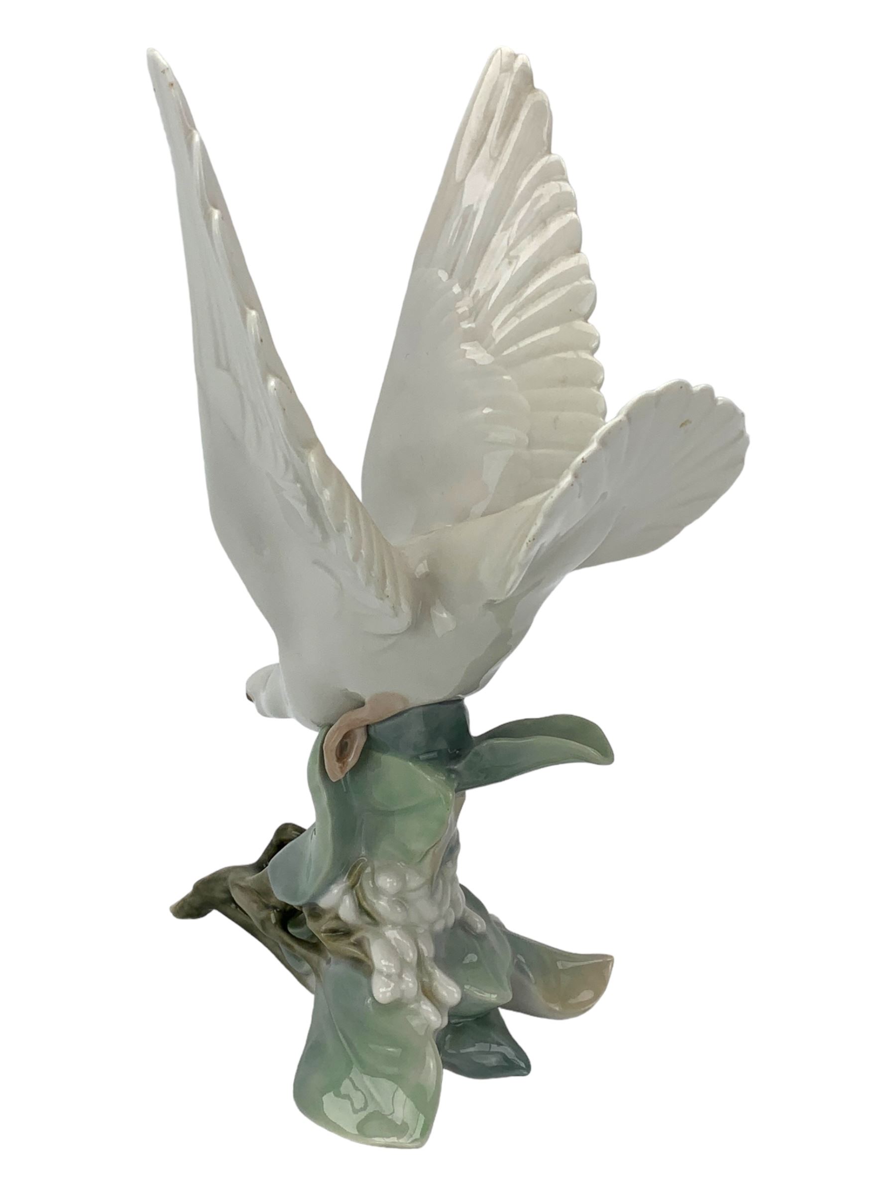 Seven Lladro figures including group of two doves, rooster, boy with accordion, deer, dove in flight , two geese and two Nao figures