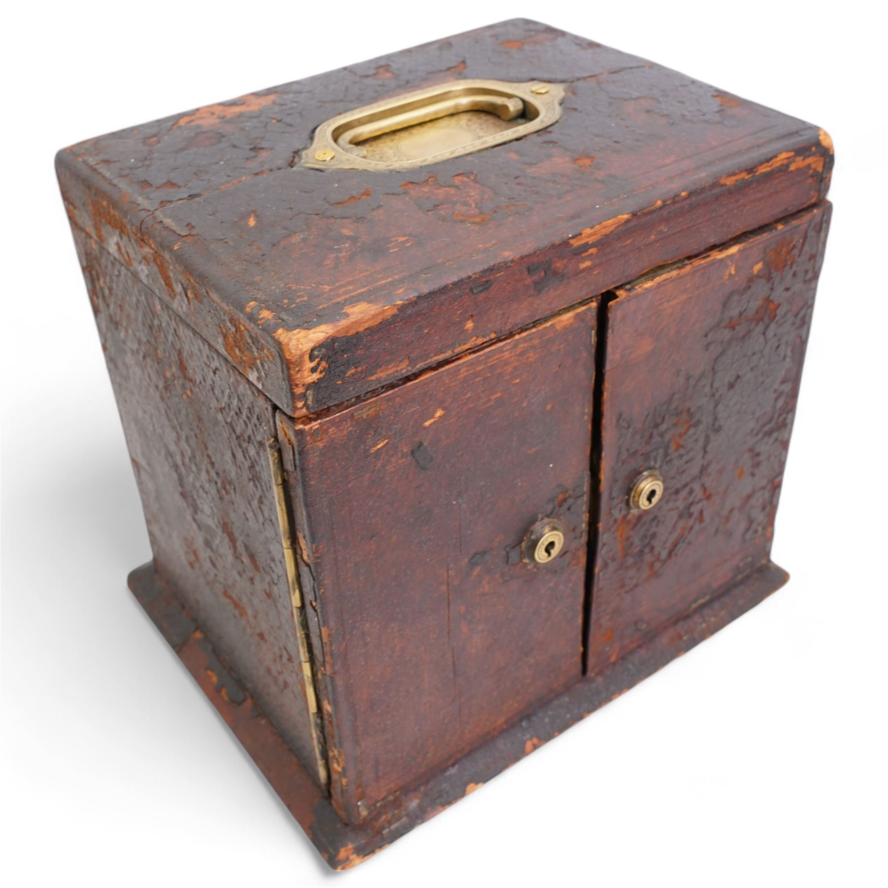 Victorian tooled leather jewellery casket, the cover with inset brass handle, two hinged doors open to reveal a top inset lined tray and central pocket watch, above two short and two long drawers, H22cm, W24.5cm, D19.5cm 