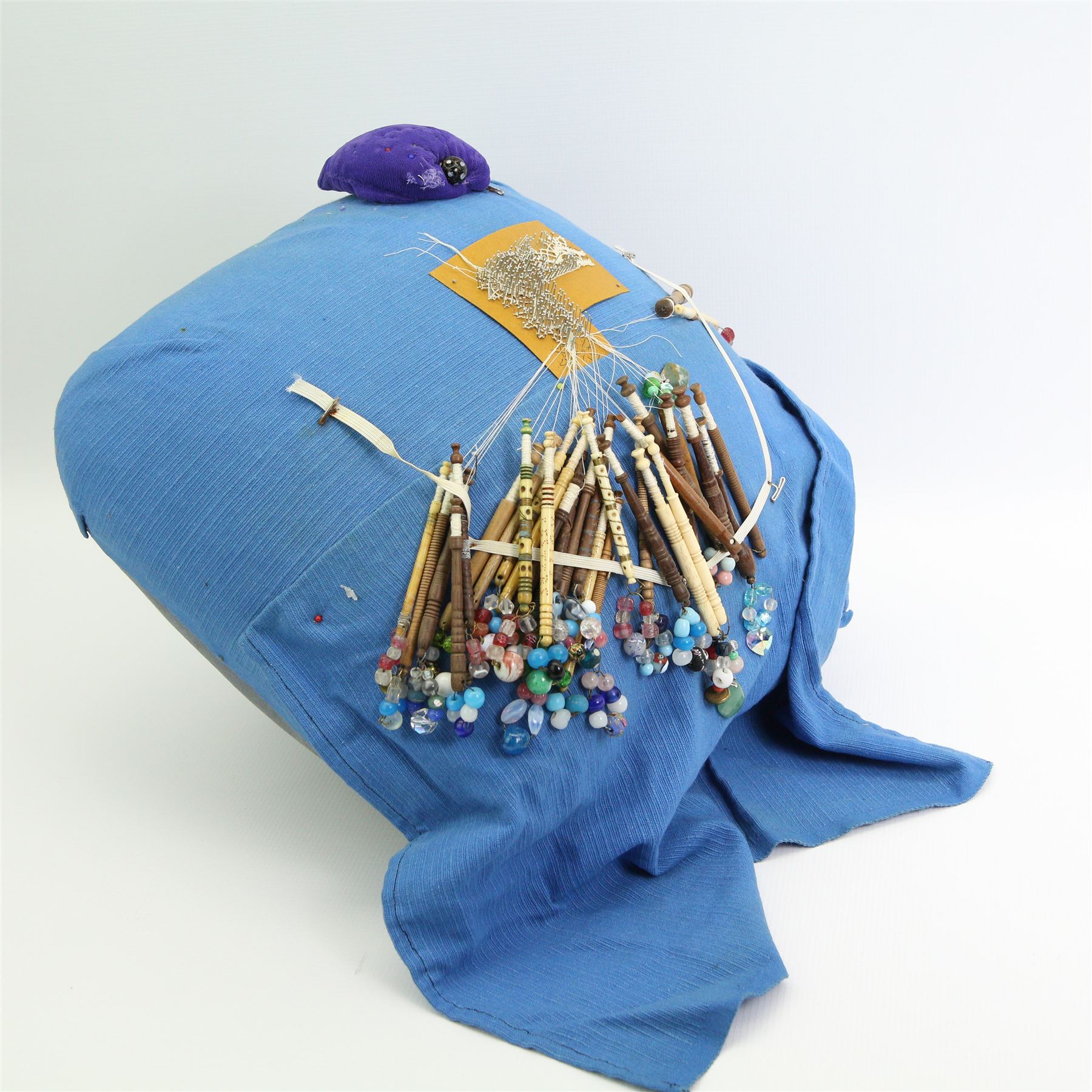 19th century and later lace maker's bone and turned wooden bobbins with glass spangles, pins, patterns, five cushions, related book and other accessories 