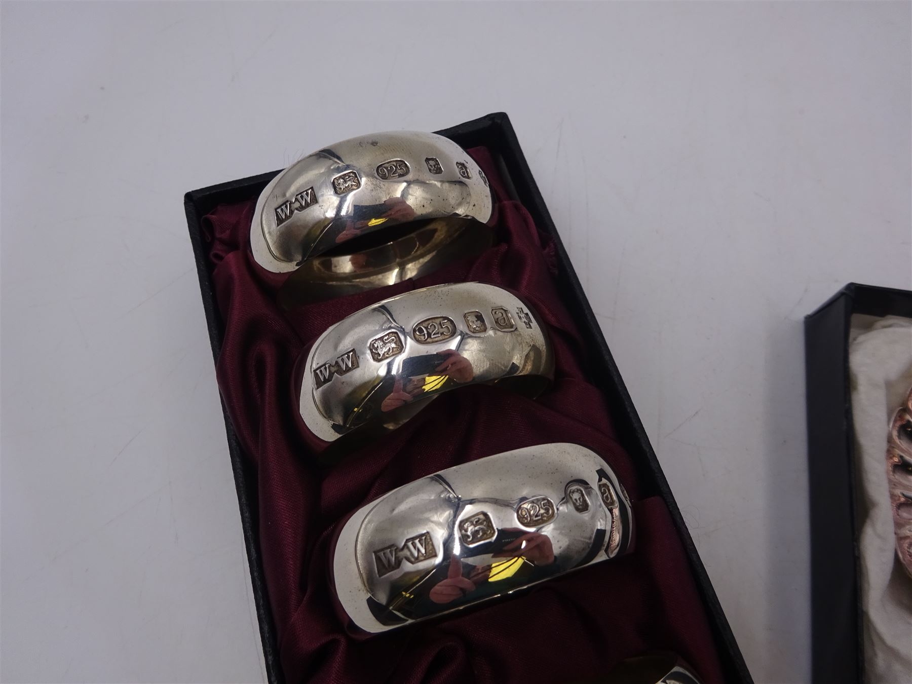 Set of six modern silver napkin rings, hallmarked London 2000, makers mark WW, together with a modern silver pin dish, hallmarked Hugh Crawshaw, Sheffield 2000, both boxed