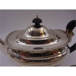 Silver three piece tea service, comprising teapot, twin handled open sucrier and a milk jug, all of oval part fluted form and upon four bun feet, the teapot with black plastic handle and finial, hallmarked S Blanckensee & Son Ltd, Chester 1930, teapot H16cm